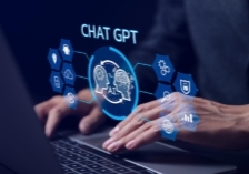 ChatGPT Chat with AI or Artificial Intelligence technology. businessman using a laptop computer chatting with an intelligent artificial intelligence. Developed by OpenAI. Futuristic technology.